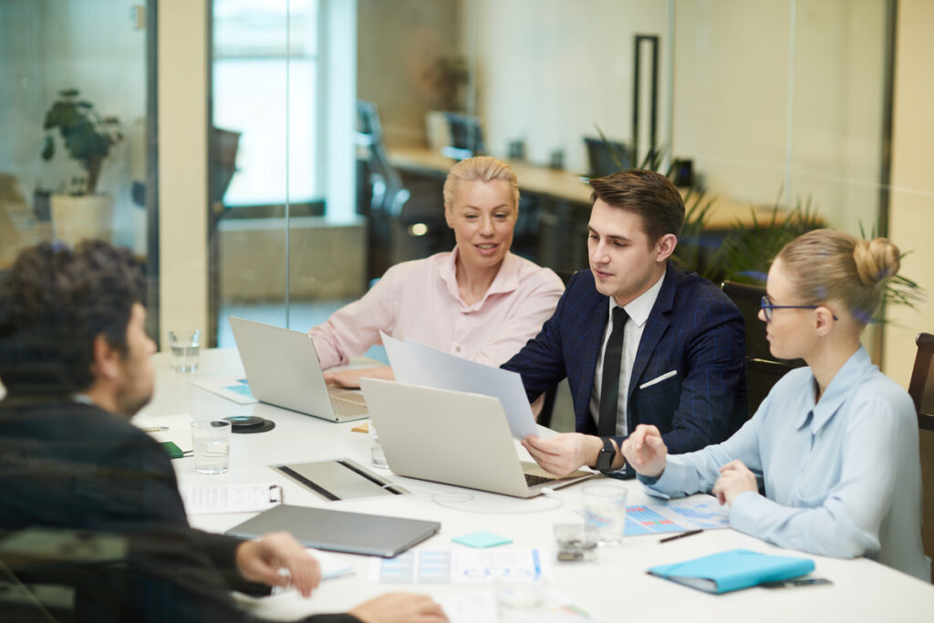 A group of business professionals brainstorming in the office.